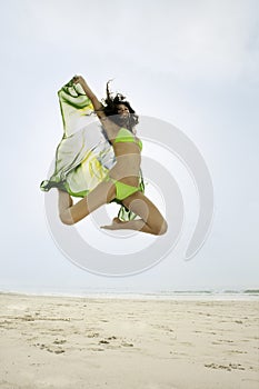 Young happy woman jumping