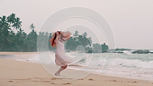 Young happy woman jumping on the ocean beach