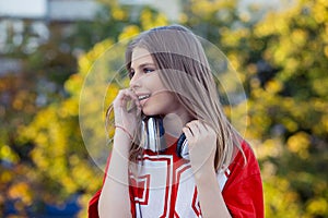 Young happy woman listening to music on headphones