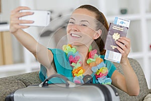 young happy woman making selfie photo with passport