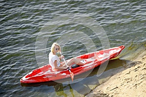 Young Happy Woman Paddling Kayak on Beautiful River or Lake at Sunset