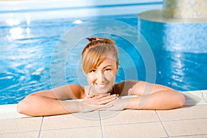 Young happy woman in pool