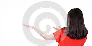 Young happy woman presenting product rear back view on white background