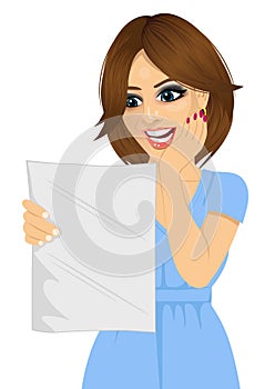 Young happy woman reading a letter with good news