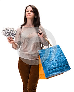 Young happy woman with shopping bags and dollar cash money