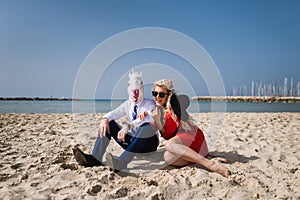 Young happy woman sits with businessman in funny mask
