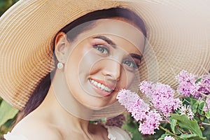 Young happy woman smiling with flowers outdoors