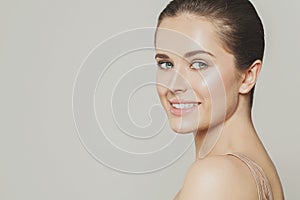 Young happy woman smiling and looking at camera. Model face close up