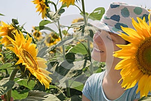 Young happy woman in sunflower field