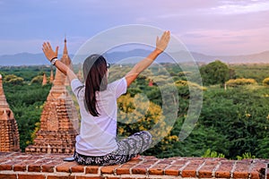 Young happy woman traveling, Asian traveler on Pagoda and looking Beautiful ancient temples, landmark and popular for tourist