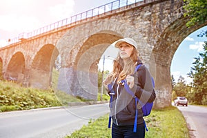 Young happy woman traveling with backpack