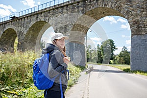 Young happy woman traveling with backpack