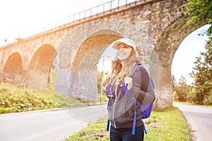 Young happy woman traveling with backpack