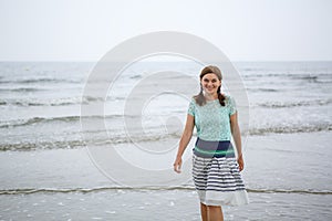 Young happy woman walking on the beach of St.Peter Ording, North