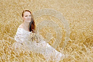 Young happy woman in wheat field