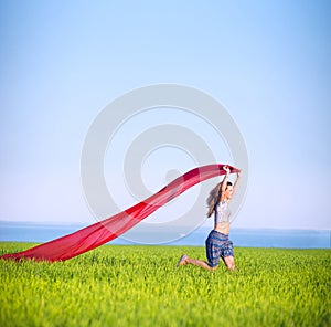 Young happy woman in wheat field with fabric
