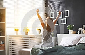 Young woman woke up in the morning in the bedroom by the windo photo
