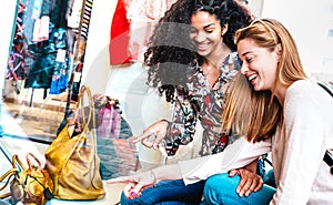 Young happy women watching display at fashion week moda shop - Best female friends sharing free time having fun shopping