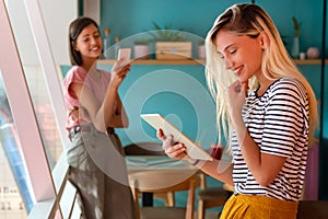 Young woman working with tablet in office. People digital device business education concept