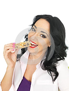 Young Healthy Attractive Woman Eating a Breakfast Cereal Bar