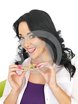 Young Healthy Attractive Woman Holding a Breakfast Cereal Bar