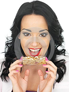 Young Healthy Attractive Woman Holding a Breakfast Cereal Bar