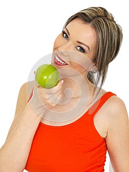 Young Healthy Attractive Woman Holding a Fresh Ripe Green Apple
