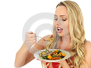 Young Healthy Fit Blonde Haired Woman Eating a Roast Vegetable Salad