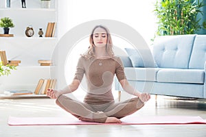 Young healthy fitness beautiful woman female doing sport exercise and yoga pose workout on mat. Healthy lifestyle, morning workout