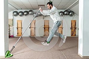 Young healthy fitness man jump with barbell weight bar as exercise for endurance and stamina