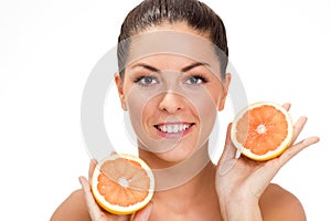 Young healthy girl holding an orange in his hand