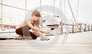 Young healthy girl tying shoe laces