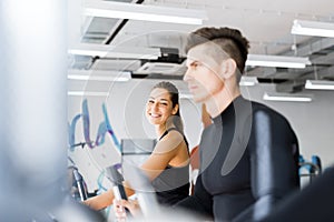 Young healthy group of people working out on a elliptic trainer