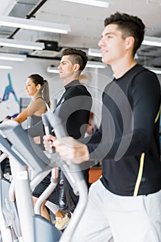 Young healthy group of people working out on a elliptic trainer