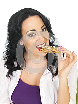 Young Healthy Happy Woman Eating a Breakfast Cereal Bar
