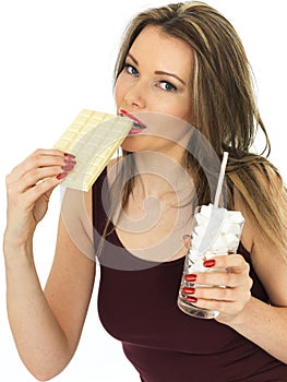 Young Healthy Woman Comparing a Chocolate Bar to a Glass of Sugar