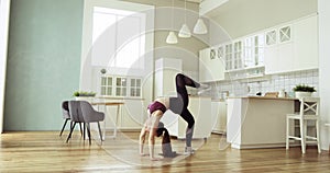 Young healthy woman practicing fitness yoga, standing in bridge pose at home.