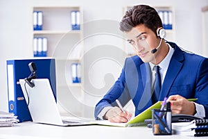 The young help desk operator working in office