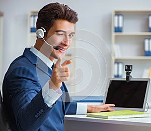Young help desk operator working in office
