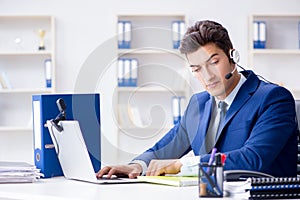 The young help desk operator working in office