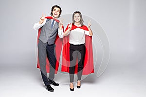 Young hero couple with red cout show peace isolated on white background