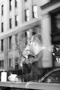 A young heterosexual couple enjoying a conversation at a nyc coffee shop