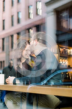 A young heterosexual couple enjoying a conversation at a nyc coffee shop