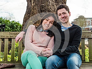 Young Heterosexual Couple Sitting on a Park Bench