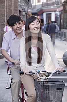 Young Heterosexual Couple on a Tandem Bicycle in Beijing photo