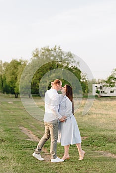 Young heterosexual pregnant couple in an outdoor park