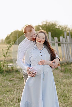 Young heterosexual pregnant couple in an outdoor park