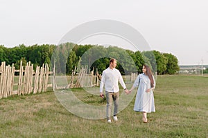 Young heterosexual pregnant couple in an outdoor park