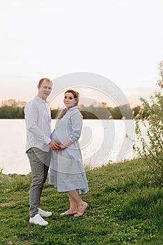 Young heterosexual pregnant couple in an outdoor park