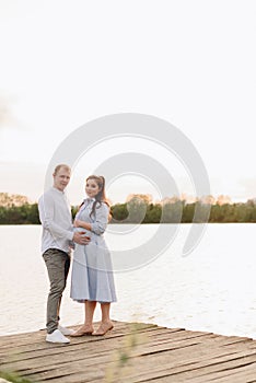 Young heterosexual pregnant couple in an outdoor park